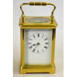 A large brass carriage clock with English movement, enamel dial and bevelled glass, 18 cm high