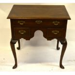 An 18th century style oak lowboy, the moulded edge top over three frieze drawers in an arched