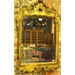 A 19th century giltwood and composite framed bevelled plate mirror in the rococo style, 87 cm x 55