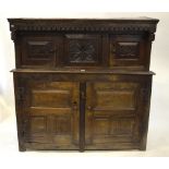A 17th century oak diadarn, the planked and jointed oak frame with deep lunette carved frieze to the