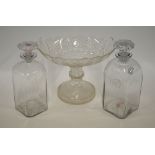 A pair of 19th century square glass decanters, one having a star cut base, the other a rough pontil,