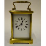 A French brass carriage clock with keyless movement and enamel dial, 14 cm high overall