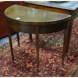 A George III mahogany demi-lune occasional table, the fold over top raised on a double gateleg