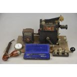 A Key W.T. 8 amp no.2 Morse Code tapper, to/w a German pipe, a cased compasses set, plated pocket