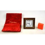 A contemporary square Cartier travelling quartz alarm clock with strut supports, having white dial