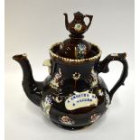 A Victorian Measham barge ware teapot, treacle glaze decorated with moulded birds and flowers and