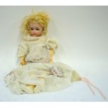 A Simon & Halbig/Kamner & Reinhart bisque-headed girl doll with blond wig, closing brown eyes,