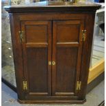 An 18th century oak hanging corner cupbo