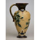A Doulton Lambeth small pear shaped jug decorated with applied flowers and foliage on an incised