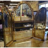 An Art Deco period arched three panel folding dressing table mirror having pink cut glass border, 80