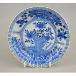 A Chinese moulded fluted saucer decorated with flower and rockwork, fungus mark, early 18th century,