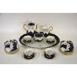 A Meissen porcelain cabaret coffee service, the dark blue body with gilt lined petal shaped panels