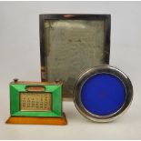 A silver and green enamel-mounted perpetual desk-calendar, Birmingham 1929, to/w two silver-framed