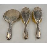 Two three-piece silver-backed brush sets including hand-mirrors, to/w a powder bowl and silver cover