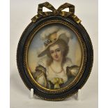 An oval portrait miniature on ivory of an early 18th century lady in feather bonnet and green dress,