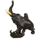 A Japanese bronze model of an elephant with ivory tusks being attacked by two tigers, seal mark to