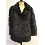 Black shearling lamb fur jacket inset with black leather with neat collar and concealed side