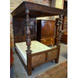 A part 17th century & later oak full tester bed, the carved and moulded panelled tester over a