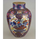 A Chinese clobbered 18th century blue and white ovoid vase decorated with three panels - flowers