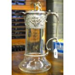 A late Victorian glass claret jug with star-cut base silver collar with embossed Bacchus masks and
