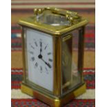 A French brass carriage timepiece, 11 cm high Condition Report Ticking, glass cracked at rear