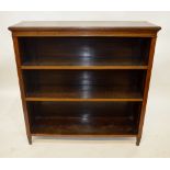 An Edwardian Sheraton Revival inlaid satin walnut open bookcase, having adjustable shelves, raised