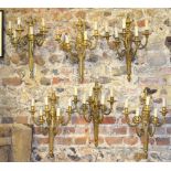 A set of six gilt brass five-sconce gira