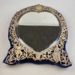 A late Victorian easel mirror with heart-shaped bevelled plate and pierced silver border worked with