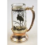 A 19th century American Aesthetic Movement large mug, the French glass body decorated in the