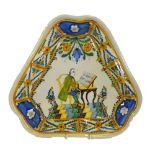 A Delft polychrome triform dish painted with a gentleman in 18th century dress seated by a table