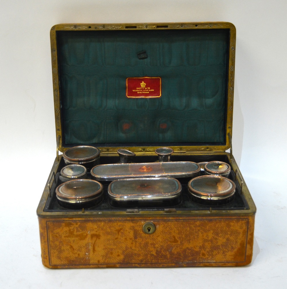 A Victorian calf-bound travelling toilet case, fitted with cut glass jars with electroplated covers,