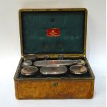 A Victorian calf-bound travelling toilet case, fitted with cut glass jars with electroplated covers,