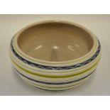 A Poole Pottery bowl of ribbed form painted with lime green concentric lines between grey and