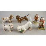 A Royal Copenhagen terrier with slipper, no 3476 to/w a Bing & Grondahl spaniel and terrier,