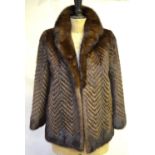 Dark and mid-brown mink, box-shaped, jacket styled with chevron pattern with neat rounded collar