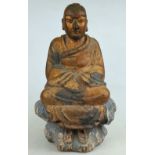 A South East Asian carved wood figure of