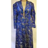 Chinese blue silk satin dressing gown patterned with temple in garden with figures, 48 cm across