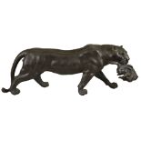 A Japanese bronze model of a leopard with a hare in his mouth, Meiji, seal mark to underside, 47.5