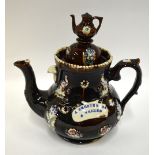 A Victorian barge ware teapot, treacle glaze decorated with moulded birds and flowers and a band