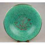 A Gustavsberg green glazed Argenta ware circular plate decorated with a central silvered floral