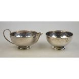 A heavy quality Art Deco silver milk and sugar pair of hemispherical form, on raised foot, Hukin &