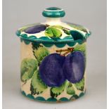 A Wemyss mustard pot and cover decorated with plums, retailed by T. Goode & Co, impressed and