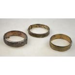 Three silver bangles, two hinged and half-engraved, one engine turned strap style, approx 2oz