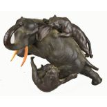 A Japanese bronze model of an elephant with ivory tusks being attacked by two tigers, seal mark to