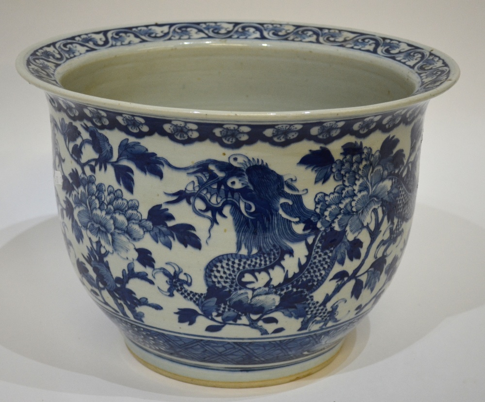 A Chinese blue and white large jardiniere decorated with two writhing dragons amidst peonies, late