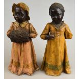 A pair of Goldscheider figures of Negro children, early 20th century, factory marks to underside
