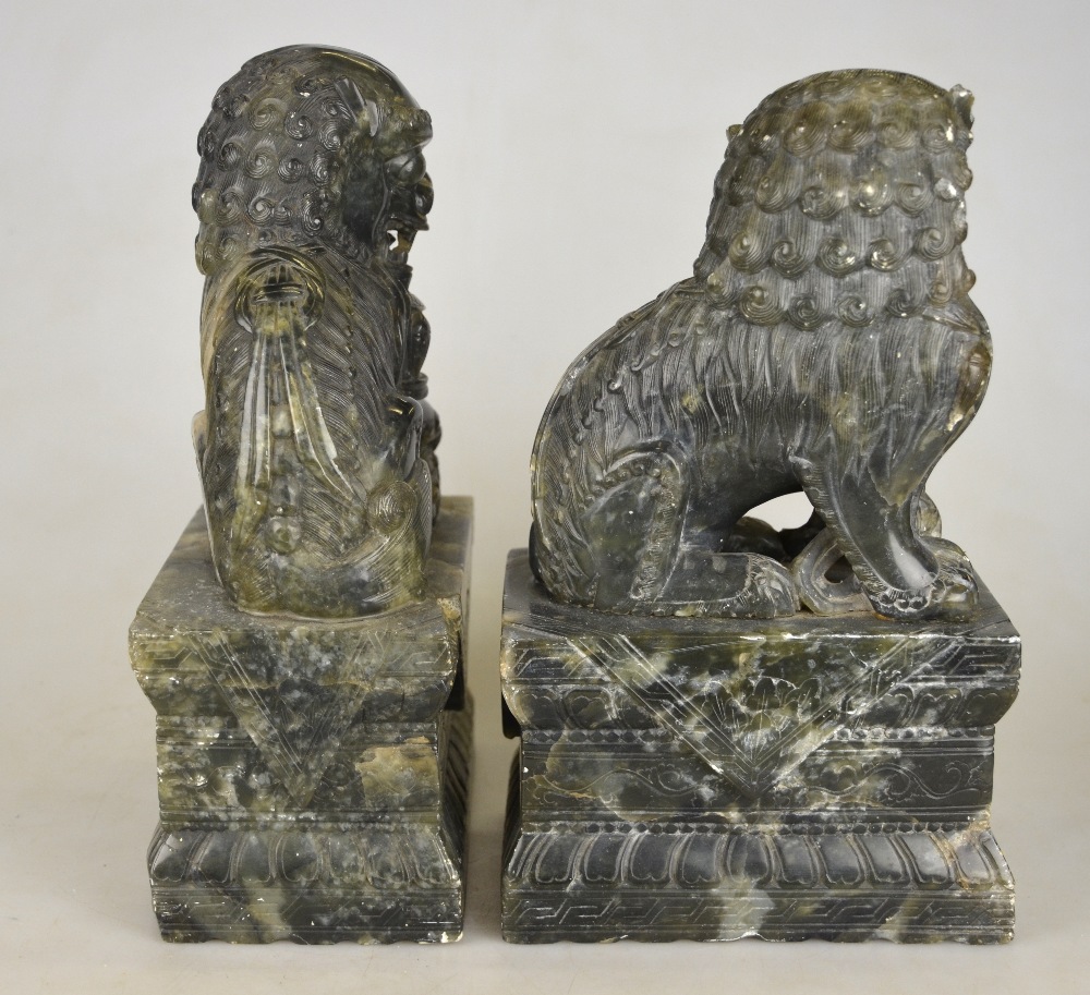 A pair of Chinese hardstone dogs of Fo seated on rectangular plinths, late 19th century, 26 cm h. - Image 4 of 4