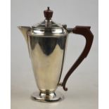 An Art Deco silver hot water jug of tapering form with composite finial and handle, William