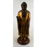A Japanese 18th century carved wood and gold lacquer figure of a standing Buddha, 37 cm high, on a