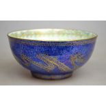 A Wedgwood lustre bowl decorated to both the interior and exterior with dragons chasing flaming